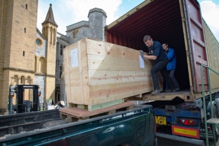 One of the pipes crates is moved out of the container